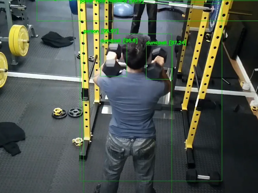 Computer-vision view from a Next! Fitness mirror: the member and both dumbbells are detected and labelled